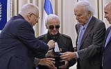 President Reuven Rivlin (L) presents French-Armenian singer Charles Aznavour the Raoul Wallenberg medal on October 26, 2017, at the President's Residence in Jerusalem. (AFP Photo/Gali Tibbon)