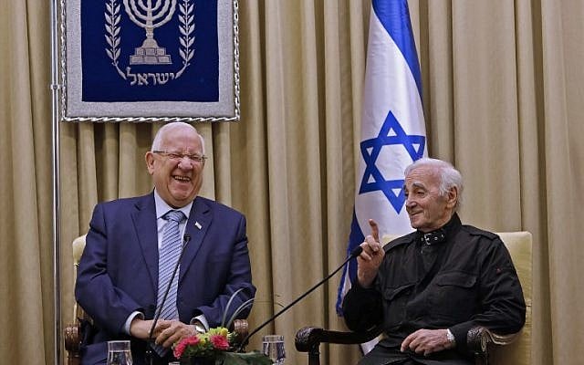 President Reuven Rivlin is seen with French-Armenian singer Charles Aznavour on October 26, 2017, at the President's Residence in Jerusalem. (AFP Photo/Gali Tibbon)