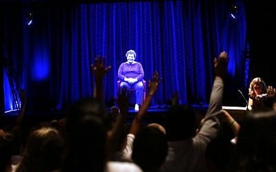 Students raise their hand as they direct questions to Holocaust survivor Adina Sella as she is displayed on a three-dimensional hologram at the Take A Stand Center in the Illinois Holocaust Museum & Education Center on October 26, 2017, in Skokie, Illinois. (Joshua Lott/AFP)