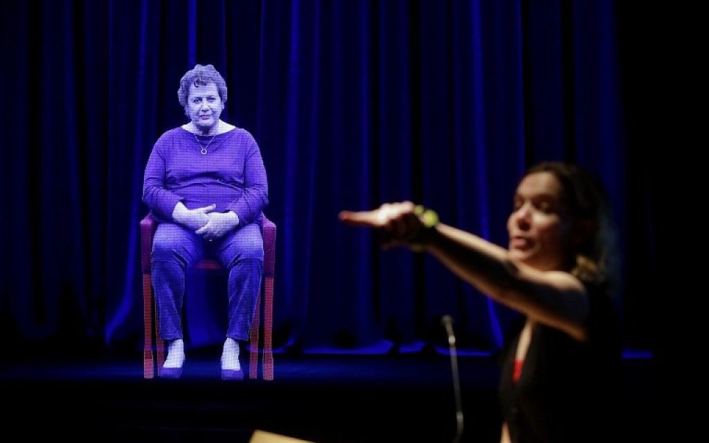 Amanda Friedeman takes a question from a student directed to Holocaust survivor Adina Sella, as she is displayed as a three-dimensional hologram at the Take A Stand Center in the Illinois Holocaust Museum and Education Center on October 26, 2017, in Skokie, Illinois. (Joshua Lott/AFP) Amanda Friedeman takes a question from a student directed to Holocaust survivor Adina Sella, as she is displayed as a three-dimensional hologram at the Take A Stand Center in the Illinois Holocaust Museum and Education Center on October 26, 2017, in Skokie, Illinois. (Joshua Lott/AFP)