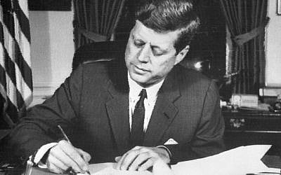 This file photo taken on October 24, 1962 shows US President John Fitzgerald Kennedy signing the order of naval blockade of Cuba at the White House in Washington, DC, during the Cuban missiles crisis. (AFP)