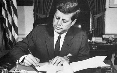 This file photo taken on October 24, 1962 shows US President John F. Kennedy signing the order of naval blockade of Cuba at the White House in Washington, DC, during the Cuban missiles crisis. (AFP)