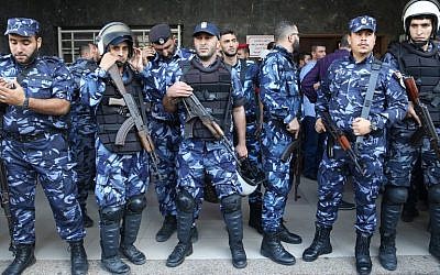 Palestinian security forces stand guard outside a hospital where a senior Hamas security chief was treated after being wounded in a car bomb.  (AFP PHOTO / MOHAMMED ABED)