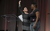 Illustrative: US actress Rose McGowan and Founder of #MeToo Campaign Tarana Burke, embrace on stage at the Women's March / Women's Convention in Detroit, Michigan, on October 27, 2017. (Rena Laverty/AFP)