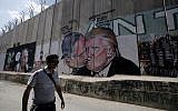 Depiction of Donald Trump kissing Netanyahu drawn on the security barrier in Bethlehem. (AFP PHOTO / Musa AL SHAER)