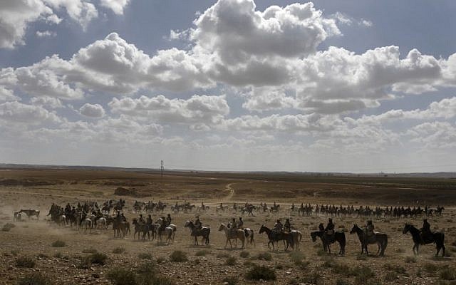 Members of the Australian Light Horse association ride towards Beer-Sheva in the northern Israeli desert on October 30, 2017 during a reenactment of the historical fight of the ANZAC (Australian and New Zealand Mounted Division) where forces captured the area from the Ottoman Empire during the First World War. (AFP PHOTO / MENAHEM KAHANA)