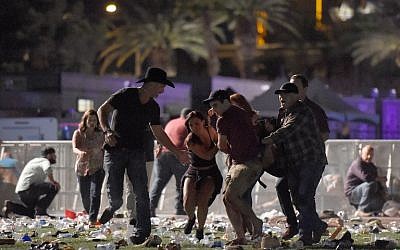 People carry a person at the Route 91 Harvest country music festival after gunfire was heard on October 1, 2017, in Las Vegas, Nevada. (David Becker/Getty Images/AFP)