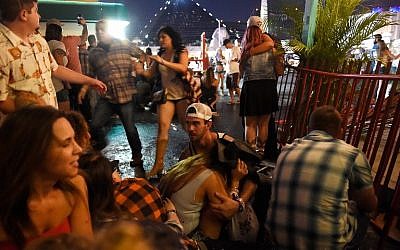People run for cover at the Route 91 Harvest country music festival after gunfire was heard on October 1, 2017, in Las Vegas, Nevada. (David Becker/Getty Images/AFP)