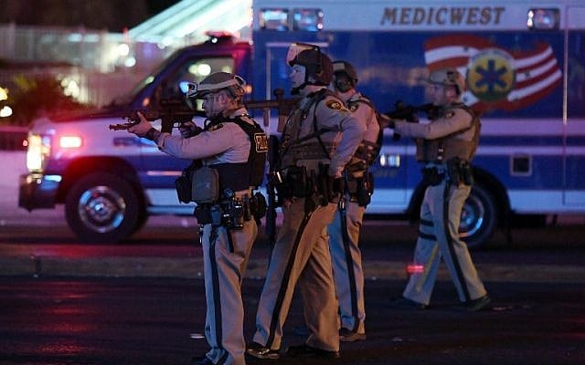 Police officers point their weapons at a car driving down closed Tropicana Ave. near Las Vegas Boulevard after a reported mass shooting at a country music festival nearby on October 2, 2017 in Las Vegas, Nevada. (Ethan Miller/Getty Images/AFP) Police officers point their weapons at a car driving down closed Tropicana Ave. near Las Vegas Boulevard after a reported mass shooting at a country music festival nearby on October 2, 2017 in Las Vegas, Nevada. (Ethan Miller/Getty Images/AFP)