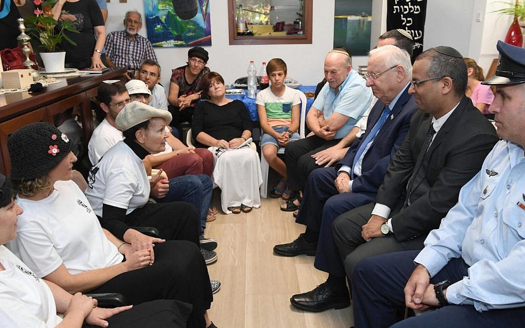 President Reuven Rivlin (3rd-R) visits the family of Reuven Schmerling, who was murdered in a terror attack, as it sits shiva, on October 15, 2017. (Mark Neyman/GPO)