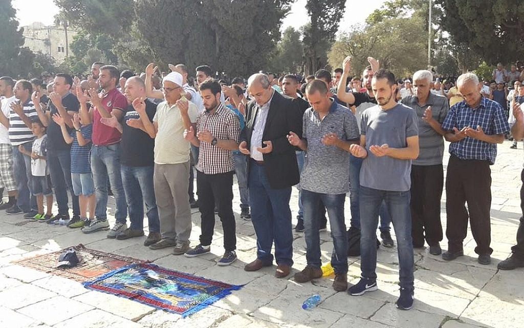 Joint (Arab) List MK Ahmad Tibi (3rd-R) prays on the Temple Mount in Jerusalem's Old City on July 27, 2017. (Ahmed Tibi's office) Joint (Arab) List MK Ahmad Tibi (3rd-R) prays on the Temple Mount in Jerusalem's Old City on July 27, 2017. (Ahmed Tibi's office)
