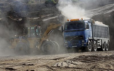 In this Tuesday, Sept. 26, 2017 photo, a bulldozer removes sand at Tel Es-Sakan hill, south of Gaza City. Palestinian and French archaeologists began excavating Gaza’s earliest archaeological site nearly 20 years ago; unearthing what they believe is a rare 4,500-year-old Bronze Age settlement.  (AP Photo/Adel Hana)