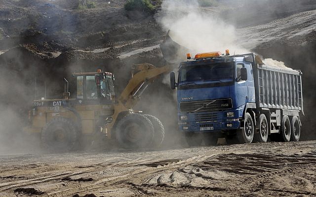In this Tuesday, Sept. 26, 2017 photo, a bulldozer removes sand at Tel Es-Sakan hill, south of Gaza City. Palestinian and French archaeologists began excavating Gaza’s earliest archaeological site nearly 20 years ago; unearthing what they believe is a rare 4,500-year-old Bronze Age settlement.  (AP Photo/Adel Hana)