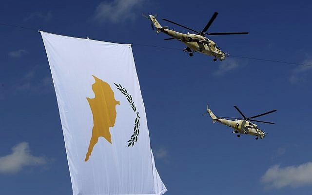 Russian-made military helicopters of the Cypriot air force fly by a Cyprus flag during a military parade marking 57th anniversary of independence, in Nicosia, in the divided island of Cyprus, October 1, 2017. (AP/Petros Karadjias)