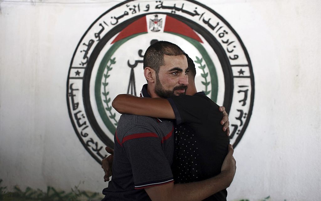 A Palestinian Fatah member receives greetings, after being released from a Hamas jail in front of the interior ministry, in Gaza City, October 1, 2017. (AP Photo/Khalil Hamra) A Palestinian Fatah member receives greetings, after being released from a Hamas jail in front of the interior ministry, in Gaza City, October 1, 2017. (AP Photo/Khalil Hamra)