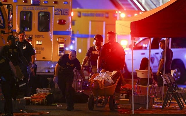 A wounded person is walked in on a wheelbarrow as Las Vegas police respond during an active shooter situation on the Las Vegas Strip in Las Vegas October 1, 2017. (Chase Stevens/Las Vegas Review-Journal via AP) A wounded person is walked in on a wheelbarrow as Las Vegas police respond during an active shooter situation on the Las Vegas Strip in Las Vegas October 1, 2017. (Chase Stevens/Las Vegas Review-Journal via AP)