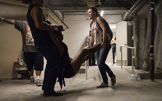 People assist a wounded woman at the Tropicana during an active shooter situation in Las Vegas Sunday on October 1, 2017. (Chase Stevens/Las Vegas Review-Journal via AP)