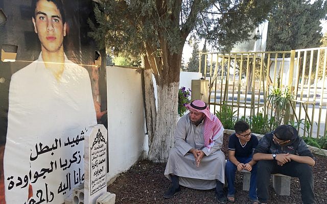 In this Wednesday, Sept. 27, 2017 photo, Zakariya al-Jawawdeh accompanied by two of his sons, 14-year-old Lukman, right, and 10-year-old Omar, visits the grave of his 16-year-old son Mohammed who was killed, along with a Jordanian man, by an Israeli embassy security guard in the Jordanian capital in July 23. (AP Photo/Karin Laub) In this Wednesday, Sept. 27, 2017 photo, Zakariya al-Jawawdeh accompanied by two of his sons, 14-year-old Lukman, right, and 10-year-old Omar, visits the grave of his 16-year-old son Mohammed who was killed, along with a Jordanian man, by an Israeli embassy security guard in the Jordanian capital in July 23. (AP Photo/Karin Laub)