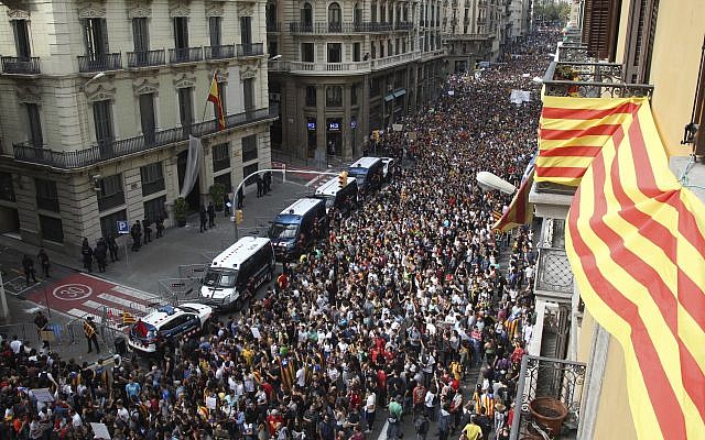 Protesters gather outside National Police Headquarters during a one-day strike in Barcelona, Spain, October 3, 2017. (AP/Bob Edme) Protesters gather outside National Police Headquarters during a one-day strike in Barcelona, Spain, October 3, 2017. (AP/Bob Edme)