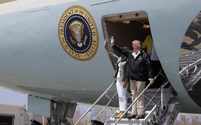 US President Donald Trump and first lady Melania Trump arrive at Luis Muniz Air National Guard Base to survey hurricane damage and recovery efforts, Tuesday, Oct. 3, 2017, in San Juan, Puerto Rico. (AP Photo/Evan Vucci)