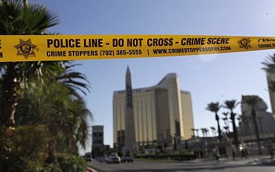 Part of Reno Ave. near South Las Vegas Blvd is blocked with police tape in the aftermath of a mass shooting Wednesday, Oct. 4, 2017, in Las Vegas. (AP/Marcio Jose Sanchez)