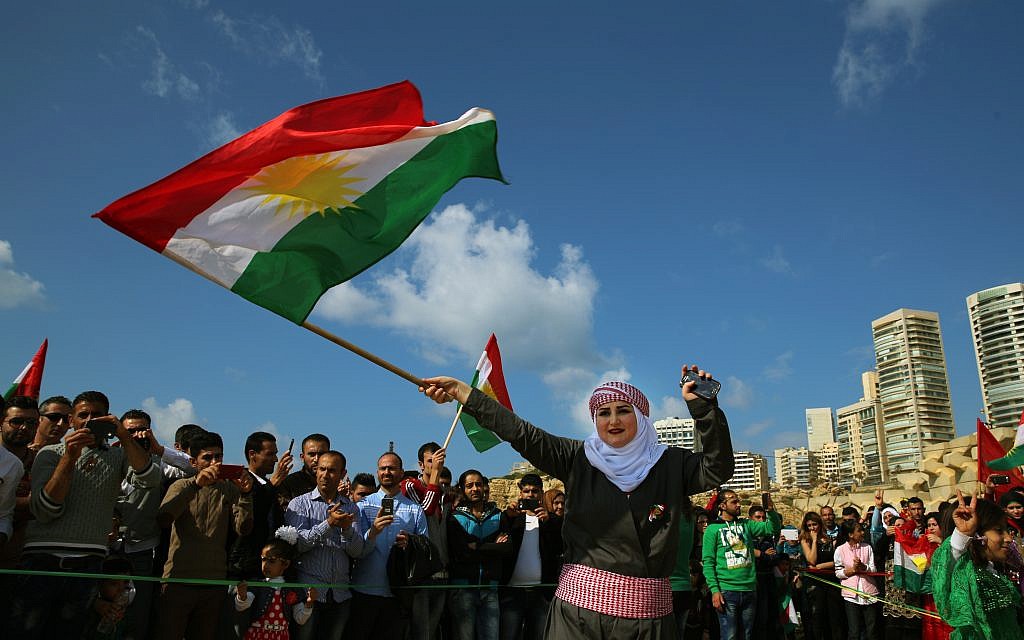 Syrian Kurd Nazdan, who fled her home in Qamishli, Syria, wears traditional clothes as she dances and waves a Kurdish flag, during a celebration of Nowruz day, in Beirut, Lebanon, March 21, 2016. (AP Photo/Bilal Hussein, File) Syrian Kurd Nazdan, who fled her home in Qamishli, Syria, wears traditional clothes as she dances and waves a Kurdish flag, during a celebration of Nowruz day, in Beirut, Lebanon, March 21, 2016. (AP Photo/Bilal Hussein, File)