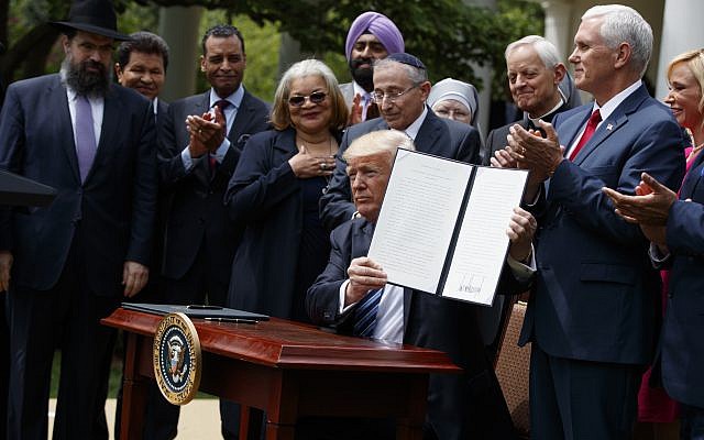 In this May 4, 2017 file photo, President Donald Trump holds up a signed executive order aimed at easing an IRS rule limiting political activity for churches in the Rose Garden of the White House in Washington. (AP Photo/Evan Vucci) In this May 4, 2017 file photo, President Donald Trump holds up a signed executive order aimed at easing an IRS rule limiting political activity for churches in the Rose Garden of the White House in Washington. (AP Photo/Evan Vucci)