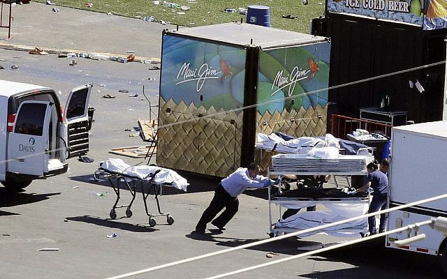 Investigators load bodies from the scene of a mass shooting at the Route 91 Harvest festival near the Mandalay Bay resort and casino on the Las Vegas Strip on in Las Vegas, October 2, 2017. (AP/Chris Carlson) Investigators load bodies from the scene of a mass shooting at the Route 91 Harvest festival near the Mandalay Bay resort and casino on the Las Vegas Strip on in Las Vegas, October 2, 2017. (AP/Chris Carlson)