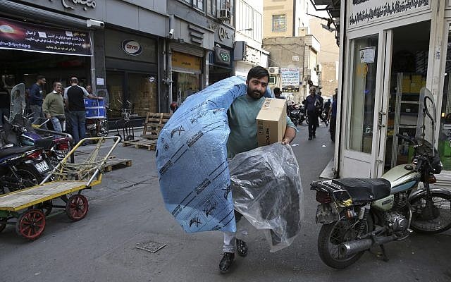 A man carries car parts at a market in downtown Tehran, Iran, October 9, 2017. (AP Photo/Vahid Salemi) A man carries car parts at a market in downtown Tehran, Iran, October 9, 2017. (AP Photo/Vahid Salemi)