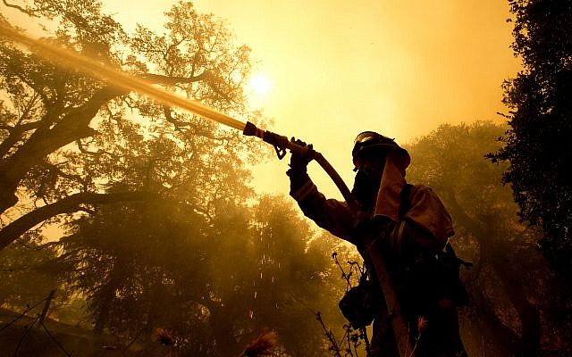 Napa County firefighter Jason Sheumann sprays water on a home as he battles flames from a wildfire Monday, Oct. 9, 2017, in Napa, California. (AP Photo/Rich Pedroncelli) Napa County firefighter Jason Sheumann sprays water on a home as he battles flames from a wildfire Monday, Oct. 9, 2017, in Napa, California. (AP Photo/Rich Pedroncelli)