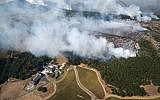 Smoke rises as a wildfire burns near Kenzo Estate in Napa, California, October 9, 2017. (Michael Short/San Francisco Chronicle via AP)