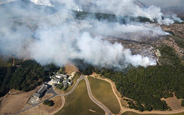 Smoke rises as a wildfire burns near Kenzo Estate in Napa, California, October 9, 2017. (Michael Short/San Francisco Chronicle via AP) Smoke rises as a wildfire burns near Kenzo Estate in Napa, California, October 9, 2017. (Michael Short/San Francisco Chronicle via AP)