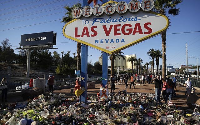 Flowers, candles and other items surround the famous Las Vegas sign at a makeshift memorial for victims of a mass shooting in Las Vegas, October 9, 2017. (AP/John Locher) Flowers, candles and other items surround the famous Las Vegas sign at a makeshift memorial for victims of a mass shooting in Las Vegas, October 9, 2017. (AP/John Locher)