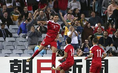 Syria's Omar Al Somah, left, jumps up after scoring against Australia during their Soccer World Cup qualifying match in Sydney, Australia, October 10, 2017. (AP Photo/Rick Rycroft)