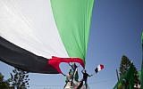 Palestinians in Gaza City wave Palestinian and Egyptian flags to celebrate the reconciliation agreement between Hamas and Fatah in Egypt, October 12, 2017. (AP Photo/Khalil Hamra)