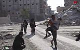 This frame grab from a video provided on Friday, Oct. 13, 2017 by Turkey-based Kurdish Mezopotamya agency media outlet  shows Syrian civilians run on a damaged street as they fleeing from the areas that still controlled by the Islamic State militants, in Raqqa, Syria. Scores of civilians including women and children are fleeing the last few remaining neighborhoods held by the Islamic State group in Syria's northern city of Raqqa, ahead of an anticipated final push by US-backed fighters seeking to liberate the city. (Mezopotamya Agency, via AP)
