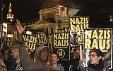 Demonstrators hold posters 'Nazis get off' during a demonstration against the Austrian Freedom Party FPOe in Vienna, Austria, Friday, Oct. 13, 2017. Austria will hold national elections on Sunday, Oct. 15, 2017. (AP Photo/Ronald Zak)