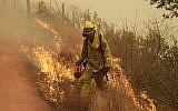 A Sonoma City firefighter walks in front of flames during a backburn operation Friday, Oct. 13, 2017, in Glen Ellen , Calif. (AP Photo/Marcio Jose Sanchez)