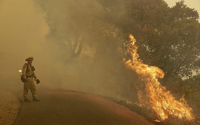 A firefighter monitors flames from a blackburn operation Friday, October 13, 2017, in Glen Ellen, Calif. (AP/Marcio Jose Sanchez) A firefighter monitors flames from a blackburn operation Friday, October 13, 2017, in Glen Ellen, Calif. (AP/Marcio Jose Sanchez)