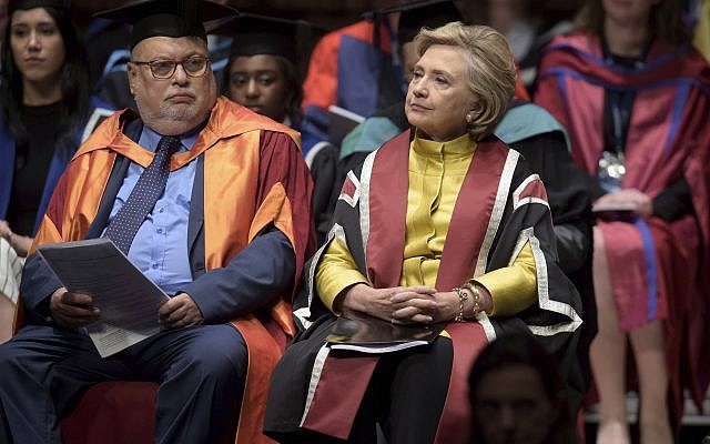 US politician Hillary Rodham Clinton, right, sits in the Great Hall at Swansea University, prior to receiving an Honorary Doctorate in recognition of her commitment to promoting the rights of families and children around the world, in Swansea, Wales, October 14, 2017. (Ben Birchall/PA via AP) US politician Hillary Rodham Clinton, right, sits in the Great Hall at Swansea University, prior to receiving an Honorary Doctorate in recognition of her commitment to promoting the rights of families and children around the world, in Swansea, Wales, October 14, 2017. (Ben Birchall/PA via AP)