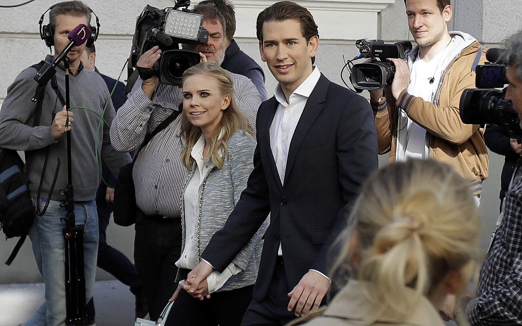 Foreign Minister Sebastian Kurz, head of Austrian People's Party, and his girlfriend Susanne Thier (L) leave the polling station after they cast their vote in Vienna, Austria, Sunday, October 15, 2017. (AP Photo/Matthias Schrader)