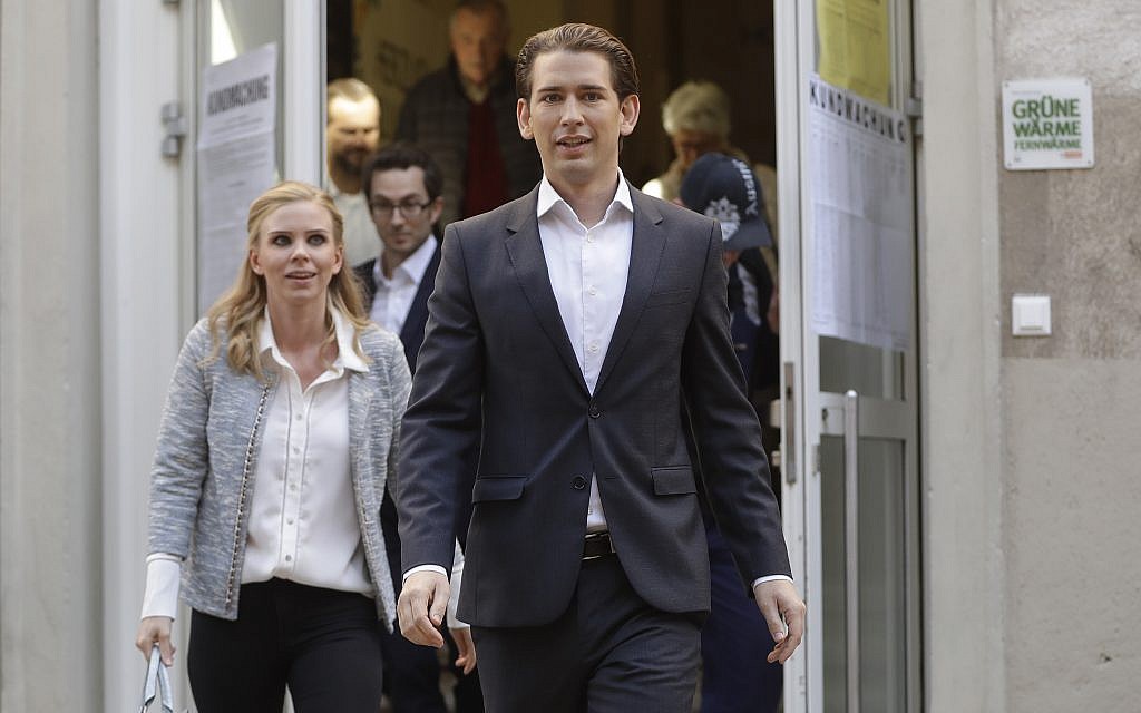 Foreign Minister Sebastian Kurz, head of Austrian People's Party, and his girlfriend Susanne Thier (L) leave the polling station after they cast their vote in Vienna, Austria, Sunday, October 15, 2017. (AP Photo/Matthias Schrader)