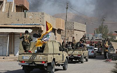 Iraqi security forces and Popular Mobilization Forces patrol in Tuz Khormato, that was evacuated by Kurdish security forces, 130 miles north of Baghdad, Iraq, Monday, Oct. 16, 2017. (AP Photo)