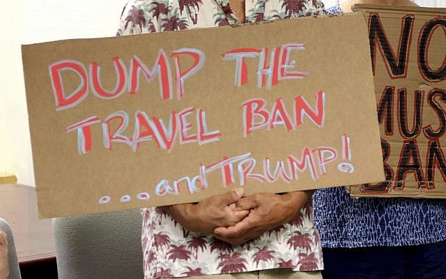 In this file photo from June 30, 2017, critics of US President Donald Trump's travel ban hold signs during a news conference in Honolulu. (AP Photo/Caleb Jones, File) In this file photo from June 30, 2017, critics of US President Donald Trump's travel ban hold signs during a news conference in Honolulu. (AP Photo/Caleb Jones, File)