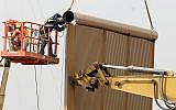 Crews work on a border wall prototype near the border with Tijuana, Mexico, Thursday, Oct. 19, 2017, in San Diego. Companies are nearing an Oct. 26 deadline to finish building eight prototypes of President Donald Trump's proposed border wall with Mexico. (AP Photo/Gregory Bull)