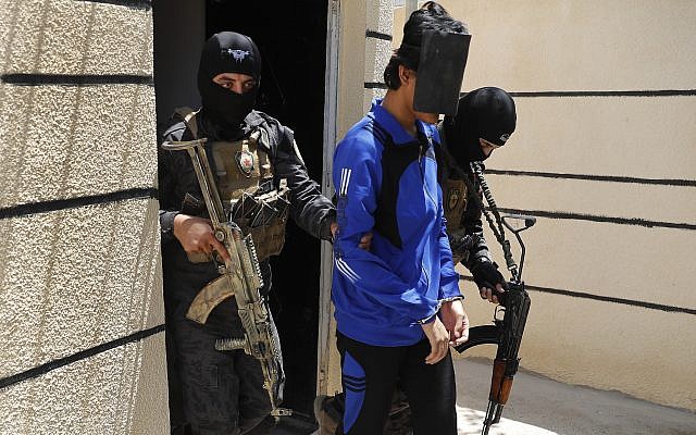 In this file picture taken on Friday, July 21, 2017, Kurdish soldiers from the Anti-Terrorism Units, carry a blindfolded an Indonesian man suspected of Islamic State membership, at a security center, in Kobani, Syria. (AP Photo/Hussein Malla, File) In this file picture taken on Friday, July 21, 2017, Kurdish soldiers from the Anti-Terrorism Units, carry a blindfolded an Indonesian man suspected of Islamic State membership, at a security center, in Kobani, Syria. (AP Photo/Hussein Malla, File)
