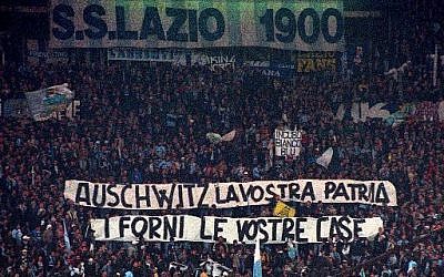 In this November 29, 1998, photo, Lazio fans display banners from the stands reading "Auschwitz is Your Homeland. The Ovens are Your Homes" during a Serie A match between Lazio and AS Roma, at Rome's Olympic stadium. (AP Photo/Plinio Lepri, files)