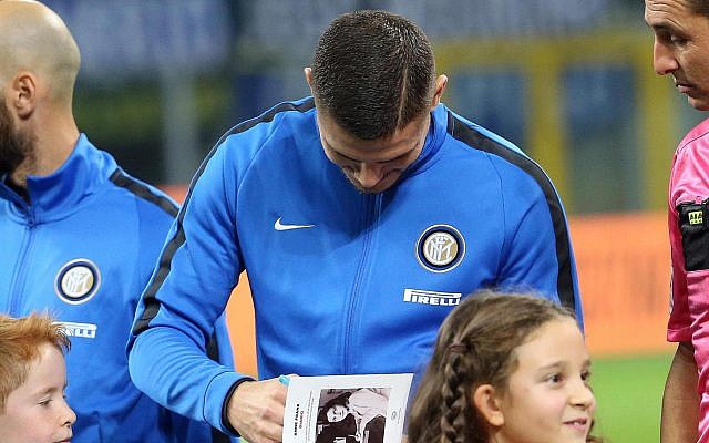 Inter's captain Mauro Icardi signs Anne Frank's diary for a child, prior to the Italian Serie A soccer match between Inter and Sampdoria at the San Siro stadium in Milan, Italy, October 24, 2017. (Matteo Bazzi/ANSA via AP) Inter's captain Mauro Icardi signs Anne Frank's diary for a child, prior to the Italian Serie A soccer match between Inter and Sampdoria at the San Siro stadium in Milan, Italy, October 24, 2017. (Matteo Bazzi/ANSA via AP)