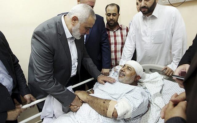 In this photo released by the Hamas media office, Ismail Haniyeh, head of the Hamas terror group's political bureau, visits Tawfiq Abu Naim at Shifa Hospital in Gaza City on October 27, 2017. (Mohammad Austaz, Hamas Media Office via AP) In this photo released by the Hamas media office, Ismail Haniyeh, head of the Hamas terror group's political bureau, visits Tawfiq Abu Naim at Shifa Hospital in Gaza City on October 27, 2017. (Mohammad Austaz, Hamas Media Office via AP)