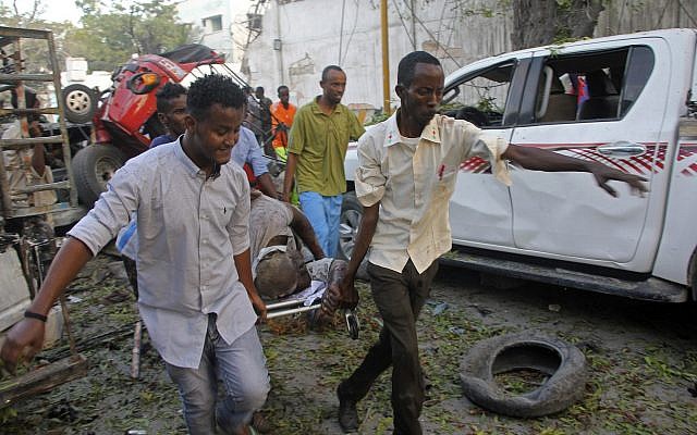 Somalis carry away the wounded civilian who was injured in a car bomb that was detonated in Mogadishu, Somalia Saturday, October 28, 2017. (AP Photo/Farah Abdi Warsameh) Somalis carry away the wounded civilian who was injured in a car bomb that was detonated in Mogadishu, Somalia Saturday, October 28, 2017. (AP Photo/Farah Abdi Warsameh)
